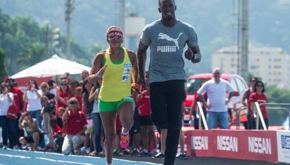 Usain Bolt corre como guía de atleta ciega
