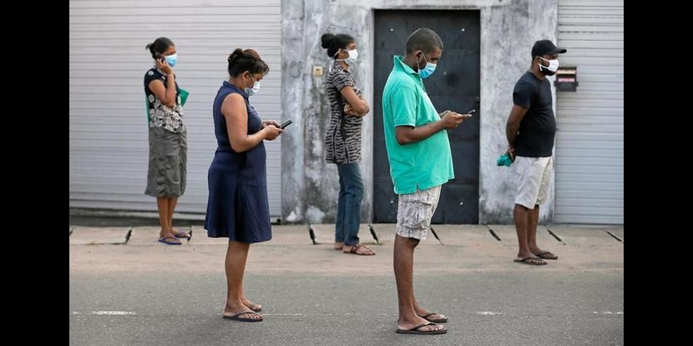 Foto 1 | Espacio al aire libre: las personas se encuentran a 1 metro de distancia mientras hacen fila para comprar comestibles en Colombo, Sri Lanka, durante un descanso en un toque de queda impuesto por el coronavirus. (Foto: REUTERS/Dinuka Liyanawatte)