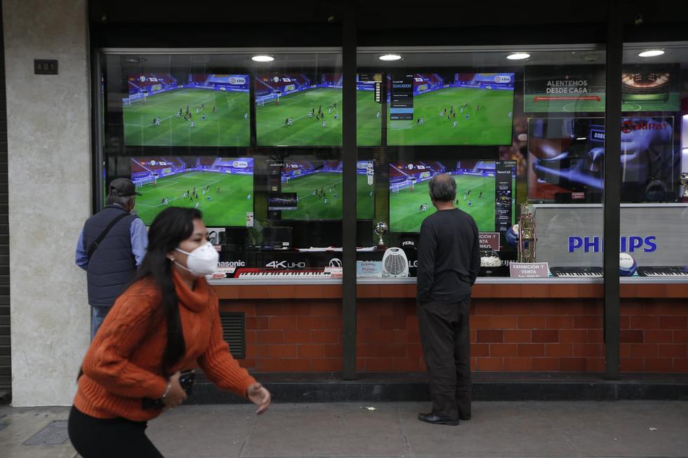 Personas de los alrededores del centro de Lima aprovecharon en ver el partido Perú vs. Venezuela en restaurantes de la zona e incluso fuera de los locales donde venden electrodomésticos, como televisores, donde se transmitía el encuentro. (Foto: Jorge Cerdan/@photo.gec)